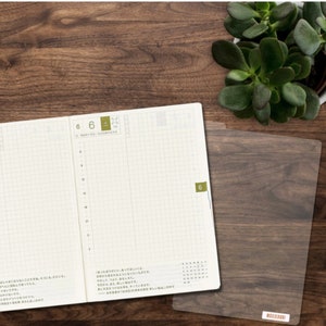 Pencil board for A6 Hobonichi slips under your page to serve as a writing surface. Get it here.