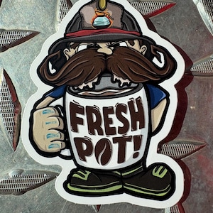 May include: A sticker featuring a cartoon character with a large brown mustache and a firefighter's hat. The character holds a coffee mug with the words "FRESH POT!" in brown letters. The sticker has a white border and is on a textured metal surface.