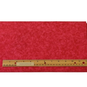 May include: A stack of red fabric with a mottled pattern. A wooden ruler, marked in inches, is placed across the fabric. The ruler has text that reads starmailia.etsy.com. The ruler is approximately 30 cm long.