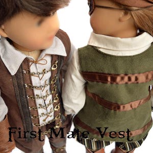 May include: Two dolls wearing brown and green vests with decorative details. The doll on the left is wearing a brown vest with gold accents and a white shirt. The doll on the right is wearing a green vest with brown ribbon accents and a white shirt. The text "First Mate Vest" is visible in the image.