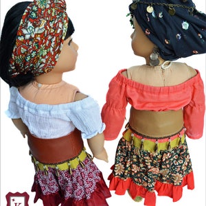 Back view of the fortune teller costumes.  One doll wears a white, off-the-shoulder shirt, a red floral headscarf, red belt and a red/floral/yellow skirt.  The other doll wears a black headscarf, salmon shirt, brown belt and green floral skirt.
