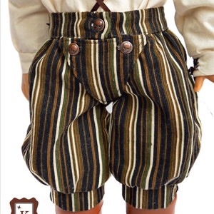 A closeup of the pants you can make with this pattern with a front fall drop section and pirate themed studs as buttons.
