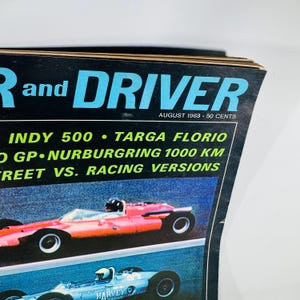 May include: A vintage magazine cover for "R and DRIVER" from August 1963. The cover features a red race car at the top and a blue race car below. The magazine title is in large blue letters, with the issue's date and price visible.