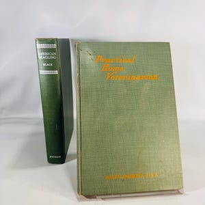 May include: Two vintage books with green covers. One book is titled "American Beagling" with "Black" below. The other book is titled "Practical Home Veterinarian" with the author's name below. Both books are in good condition.