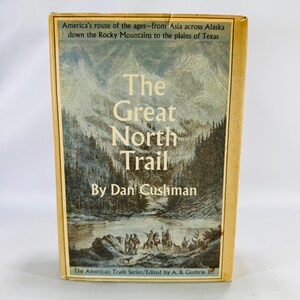 May include: A vintage book titled "The Great North Trail" by Dan Cushman. The cover features a landscape illustration of mountains and trees, with text that reads "America's route of the ages..." and "The American Trails Series."