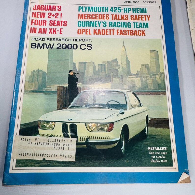 May include: A magazine cover from April 1966 showcasing a white BMW 2000 CS coupe. Headlines include "Jaguar's New 2+2! Four Seats in an XK-E" and "Plymouth 425-HP Hemi." The cover also displays the text "Road Research Report: BMW 2000 CS."