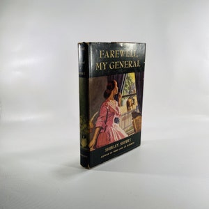 May include: A vintage hardcover book titled "Farewell, My General" by Shirley Seifert, author of "Three Lives of Elizabeth." The cover features a woman in a pink dress looking out a window.