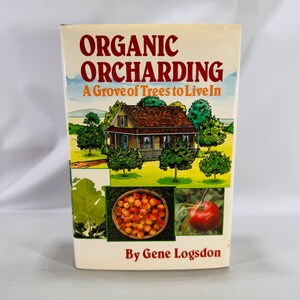 May include: A book titled "Organic Orcharding" with a cover illustration of a house, trees, and fruit. The cover also features the text "A Grove of Trees to Live In" and "By Gene Logsdon". The book's cover is cream-colored with red and green accents.
