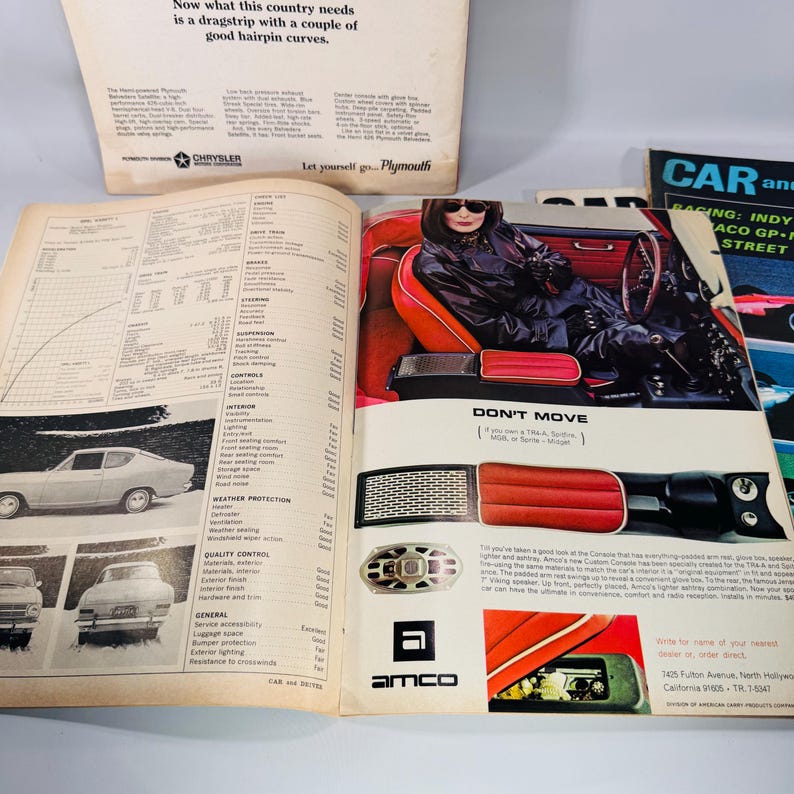 May include: A selection of vintage car magazine pages. One page shows a car interior with a person in a black outfit. Another page displays car diagrams and specifications. The text "DON'T MOVE" is visible.