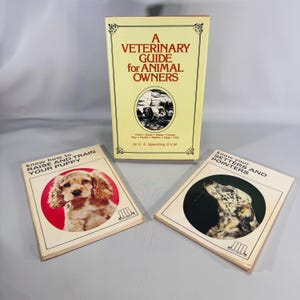 May include: Three vintage books on a light background. The largest book is titled "A Veterinary Guide for Animal Owners." Two smaller books are titled "Know How to Raise and Train Your Puppy" and "Know Your Setters and Pointers."