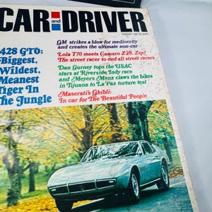 May include: Vintage February 1966 Car and Driver magazine cover. Features a silver Maserati Ghibli sports car on a road with trees. Headlines include "428 GTO: Biggest, Wildest, Meanest Tiger In The Jungle."
