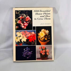 May include: A hardcover book titled "1000 Beautiful House Plants and How to Grow Them" by Jack Kramer. The cover features a collage of colorful house plant photographs, including pink and red flowers, and white and red poinsettias.