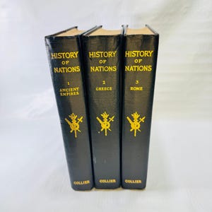 May include: Three black hardcover books titled History of Nations, numbered 1, 2, and 3, with subtitles Ancient Empires, Greece, and Rome. Each spine features gold lettering and a gold emblem of crossed swords and a shield, with Collier at the base.