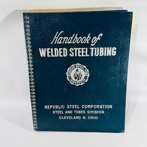 May include: A dark blue spiral-bound book titled Handbook of WELDED STEEL TUBING. The cover features the Formed Steel Tube Institute logo and text identifying the Republic Steel Corporation, Steel and Tubes Division, Cleveland 8, Ohio.