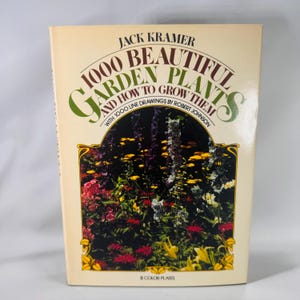 May include: A vintage book titled "1000 Beautiful Garden Plants and How to Grow Them" by Jack Kramer. The cover features colorful flowers and the text is in a serif font. The book has 8 color plates.