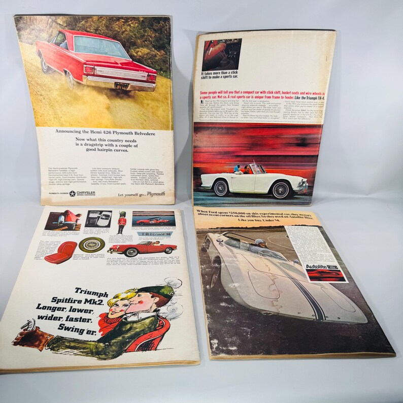 May include: Four vintage magazine adverts displaying classic cars. The adverts feature a red Plymouth Belvedere, a white convertible, and a silver sports car. Text includes "Announcing the Hemi 426 Plymouth Belvedere" and "Triumph Spitfire Mk2."