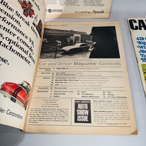 May include: An open vintage "Car and Driver Magazine" with articles and images of classic cars. The cover features a black and white photo of a car. The magazine is open to the contents page.