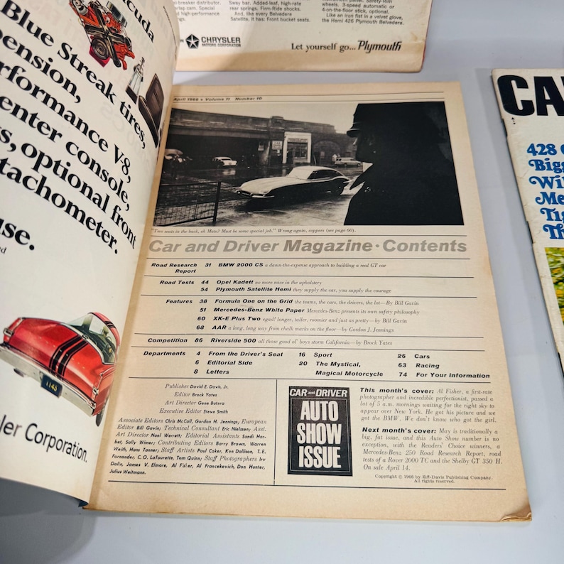 May include: An open vintage "Car and Driver Magazine" with articles and images of classic cars. The cover features a black and white photo of a car. The magazine is open to the contents page.