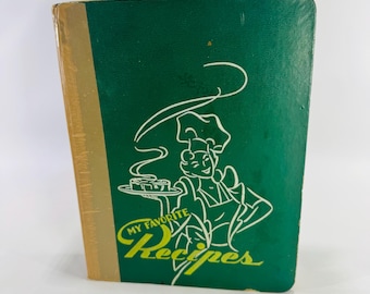 May include: A vintage cookbook with a green cover and gold spine. The cover features a white illustration of a chef holding a tray of food, with the words "My Favorite Recipes" in yellow script.