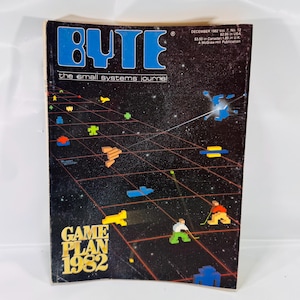 May include: A vintage "BYTE" magazine cover from December 1982, featuring a retro video game-themed illustration. The cover has a dark background with a grid pattern and pixelated figures. The magazine title is in blue, with the text "GAME PLAN 1982".
