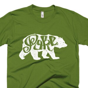 May include: A green t-shirt with a white bear silhouette. The bear is made up of the word "Bear" in a stylized font.