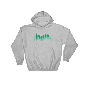 May include: A heather grey hooded sweatshirt with a forest silhouette design in shades of green. The design features a row of trees with a gradient of green hues.