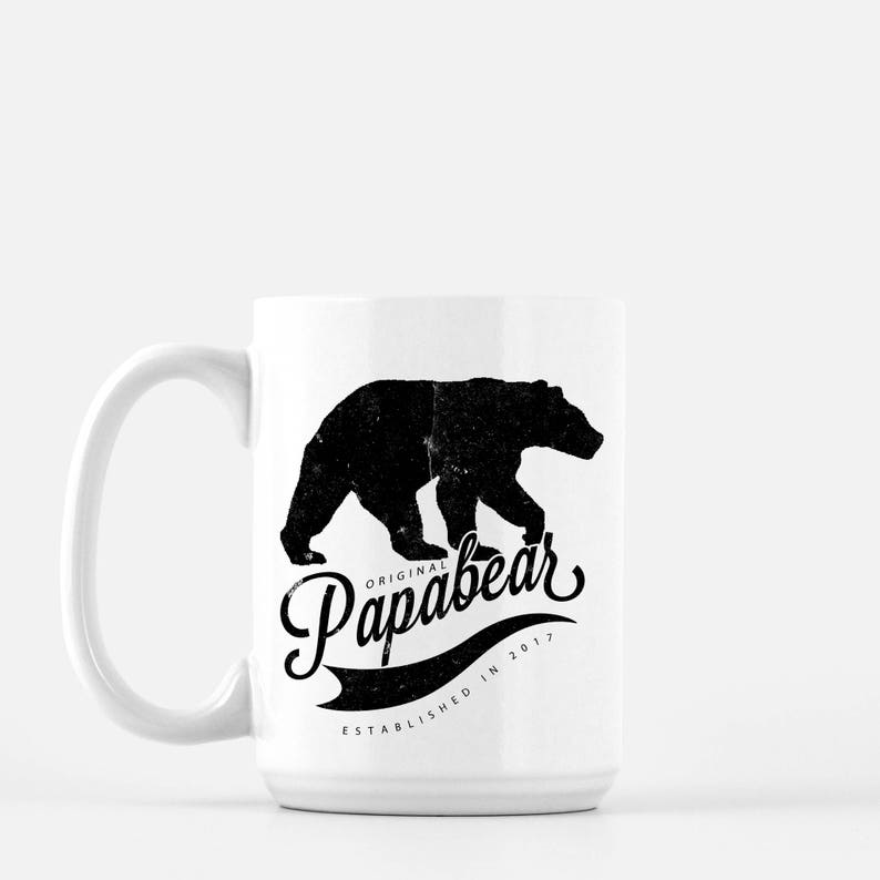 May include: White ceramic mug with a black silhouette of a bear walking to the right. The text "Original Papabear Established in 2017" is printed below the bear.