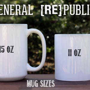 May include: Two white ceramic mugs with black text. The larger mug is 15 oz and the smaller mug is 11 oz. The text "GENERAL [RE]PUBLIC" is at the top of the image.