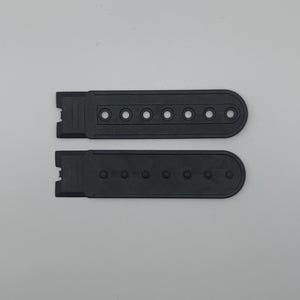 May include: Two black hat adjustment straps. Each strap is rectangular with a rounded end and a series of seven evenly spaced holes. One end of each strap has a notched design for attachment. The straps are made of a matte black material.