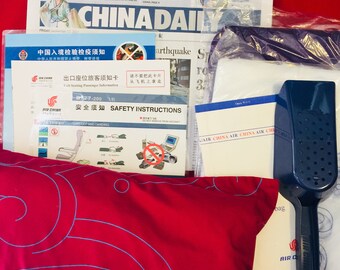 AIR CHINA B-777 passenger briefing card and amenity package
