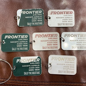 Former Frontier Airlines Airbus 320 fuselage skin key chain.