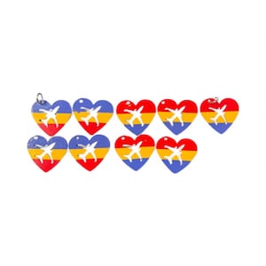 May include: A collection of heart-shaped charms with a painted airplane design. Each charm features a color scheme of red, yellow, and blue, with a silver-colored loop at the top for hanging. The charms are likely for jewelry or craft projects.