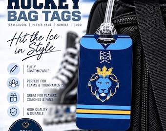 May include: A rectangular hockey bag tag featuring a dark blue jersey design with light blue and yellow stripes, a white lace-up collar, and a central lion head logo wearing a crown. The tag is attached to a black bag with a clear plastic loop.