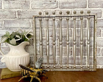 May include: A silver metal decorative wall panel with a grid of vertical bars. The panel has a rustic, distressed look and is perfect for adding a touch of farmhouse style to any room.