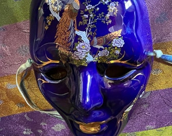 Cobalt Blue ceramic mask wall decor beautifully decorated with peacock gold gilt  painted signed . VGC blue and gold glazed wall art