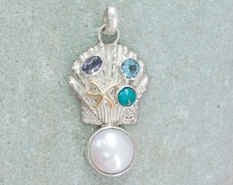 Silver Sea Shell Pendant encrusted with Gemstones and a tiny stsrfish all accented  with a big beautiful Pearl!