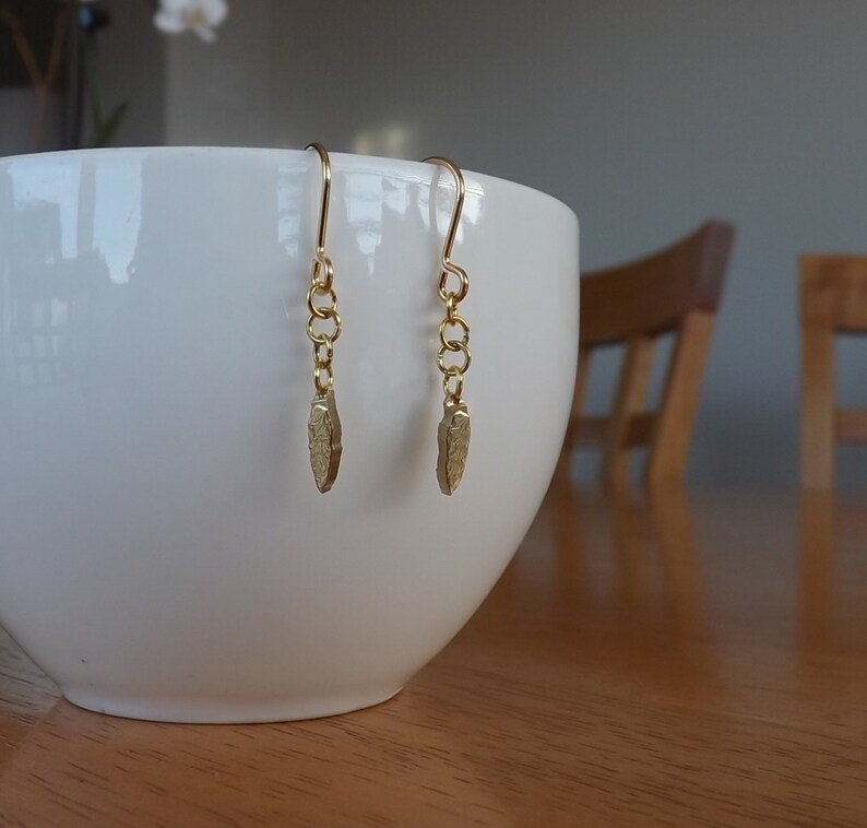 Drop earrings of /'leaf-shaped tool/' from a Polish 2 zlote coin dated 2012 commemorating the Krzemionki archaeological site in Poland