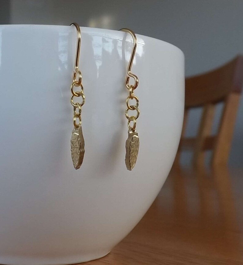 Drop earrings of /'leaf-shaped tool/' from a Polish 2 zlote coin dated 2012 commemorating the Krzemionki archaeological site in Poland