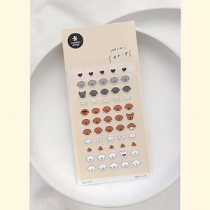 May include: A sheet of stickers featuring various illustrations of dogs. The stickers are on a white background with the text "mini series" and "NO. 117 DECO. 10" at the bottom.