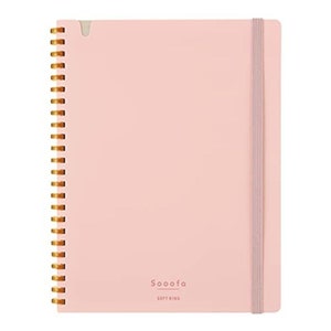 May include: A pink spiral bound notebook with a gold coil and a pink ribbon closure. The notebook has the text "Sooofa Soft Ring" printed on the front cover.