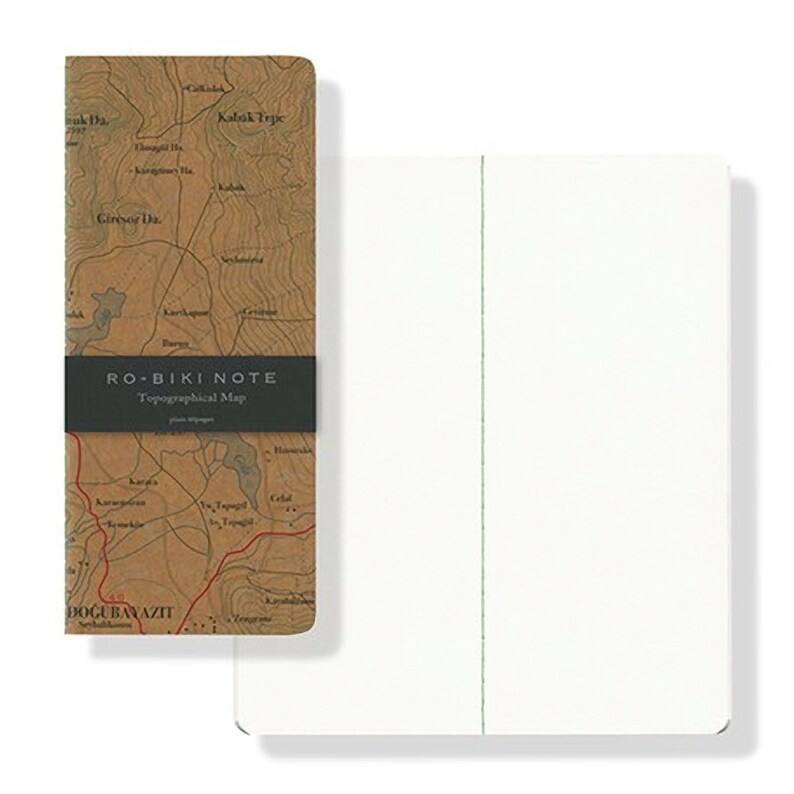 May include: A brown notebook with a topographical map on the front cover. The cover has the text "RO-BIKI NOTE Topographical Map" printed on it. The notebook is closed and the spine is visible. The notebook is on a white background.