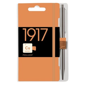 May include: An orange notebook and pen set. The notebook has the number "1917" printed on the front. A pen loop and a silver pen are attached to the notebook. The pen loop has the chemical symbol "Cu" printed on it.