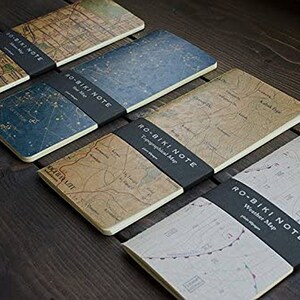 May include: Five different notebooks with black covers and map designs. The covers feature the text "RO-BIKI NOTE" and the type of map, such as "Topographical Map" or "Weather Map".