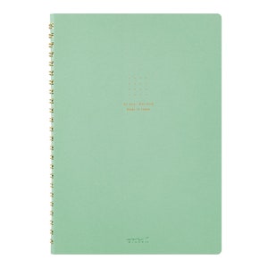 May include: A light green spiral bound notebook with a gold wire binding. The notebook has a dotted grid pattern and the text "A5 size / Dot Grid Made in Japan" printed in gold on the front cover. The text "MIDORI" is printed in gold at the bottom of the cover.