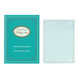May include: A teal blue notepad with a gold border and the text "Macaron Color Sticky Notes" and "20 sheets". The notepad is next to a light blue sticky note with a gold border.