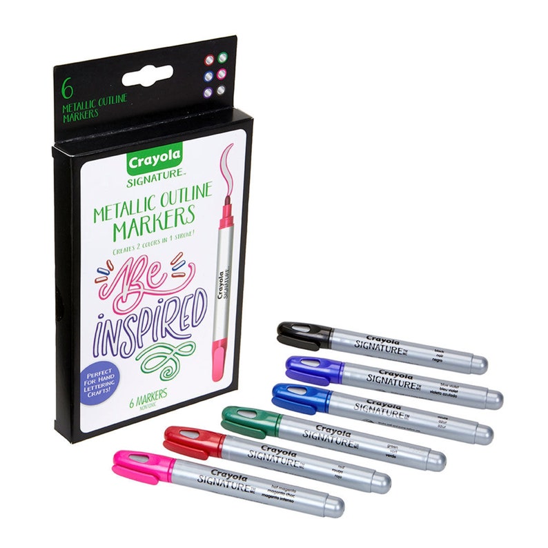 May include: A set of six Crayola Signature Metallic Outline Markers in a black box. The markers are silver with colored caps and tips. The colors are pink, red, green, blue, black, and silver. The box has the text "Crayola Signature Metallic Outline Markers" and "Be Inspired".