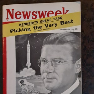 May include: A vintage Newsweek magazine cover featuring a black and white illustration of a man with glasses. The cover headline reads "KENNEDY'S GREAT TASK Picking the Very Best (NATIONAL AFFAIRS)" and the date is December 19, 1960. The cover also features a rocket ship and a wagon in the background.