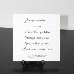 May include: White ceramic tile with black text that reads "Always remember... you are Braver than you believe Stronger than you seem Smarter than you think Loved more than you know."