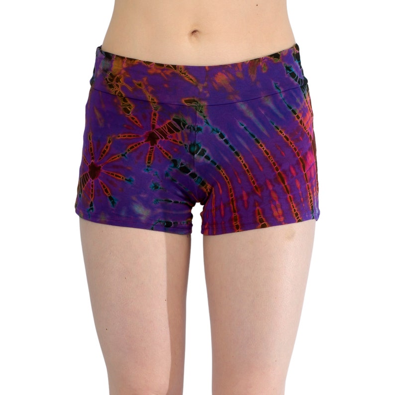 May include: Purple tie-dye shorts with a black waistband. The shorts have a colorful pattern with orange, red, and blue accents.