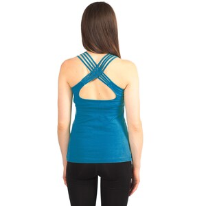 May include: A teal blue tank top with a criss-cross strap design at the back.